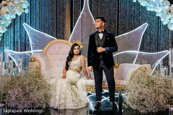 reception stage,luxury wedding decor,formal portraits,evening reception,lotus backdrop,bride and groom,glamorous styling,wedding fashion,elegant reception,destination wedding