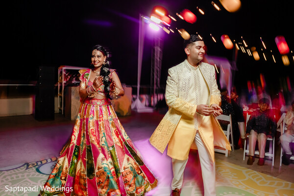 sangeet performance,dance floor,colorful lehenga,groom fashion,wedding entertainment,pre wedding celebration,vibrant lighting,destination wedding,festive atmosphere,cultural festivities