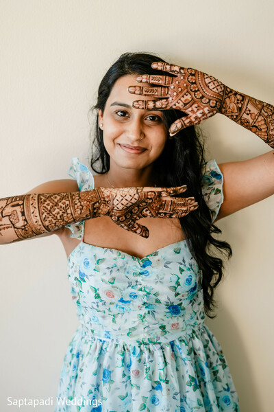 bridal mehndi,henna artistry,floral dress,mehndi ceremony,bridal portrait,intricate patterns,pre wedding events,cultural traditions,south asian bride,bridal beauty