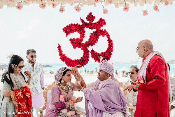 sindoor ceremony,hindu wedding rituals,om symbol,sacred traditions,destination wedding,wedding ceremony,cultural celebration,bride and groom,family blessings,spiritual moments