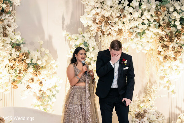 wedding speech,emotional moments,reception celebration,bride speech,groom reaction,floral backdrop,wedding toasts,candid moments,luxury reception,heartfelt memories