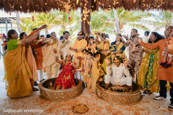 haldi ceremony,flower petals,family celebration,pre wedding rituals,candid moments,wedding traditions,joyful atmosphere,destination wedding,cultural celebration,haldi fun