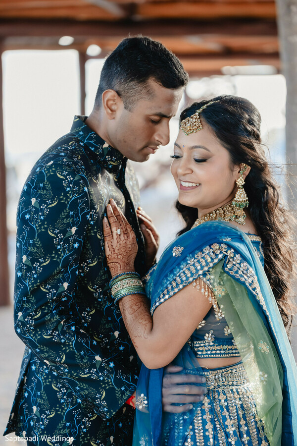 couple closeup,blue lehenga,bridal jewelry,mehndi details,romantic portraits,destination wedding,bride and groom,wedding fashion,intimate moments,south asian wedding