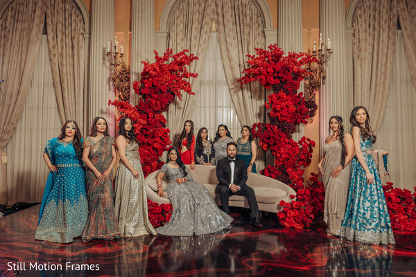 bridal party,group portraits,floral installation,reception decor,wedding celebration,luxury wedding,wedding party,elegant portraits,red flowers,reception styling