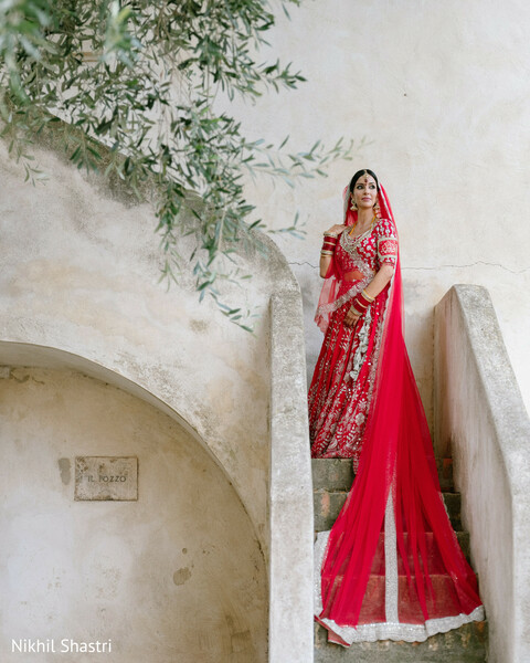 bridal portraits,red veil,dramatic photography,wedding fashion,bridal elegance,staircase portraits,south asian bride,luxury wedding,bridal style,romantic portraits