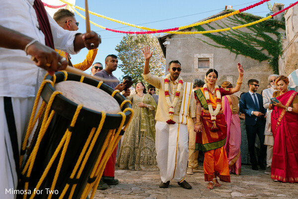 wedding procession,cultural traditions,couple entrance,celebration,south asian wedding,dancing guests,candid photography,wedding festivities,traditional attire,joyful moments