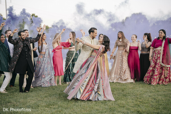 sangeet,first dance,colorful smoke,wedding entertainment,celebration,dance floor,wedding guests,vibrant wedding,joyful moments,south asian wedding