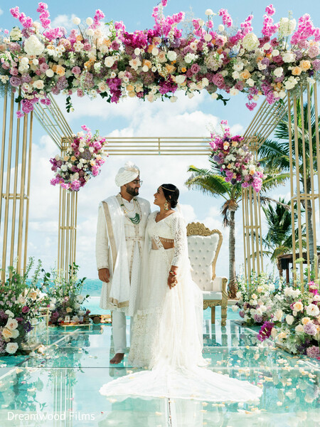 floral mandap,wedding ceremony,bride and groom,destination wedding,beach wedding,ocean views,luxury wedding,indian wedding,tropical wedding,ceremony decor