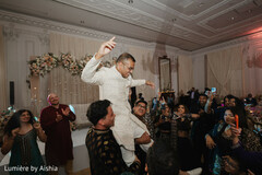 South Asian Groom Carried on Shoulders at Lively Wedding Reception