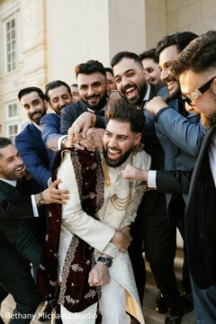 Groom and Groomsmen Playfully Pose in Traditional and Modern Attire