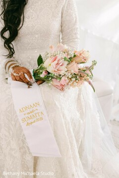 Bride Holding Pink Rose Bouquet with Personalized Sash