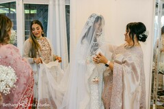 Bride in White Gown Getting Ready with Others