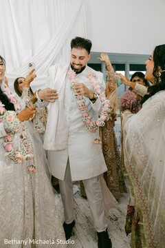Groom in White Sherwani with Floral Garlands
