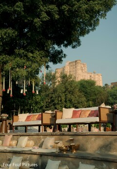Outdoor Lounge Seating with Floral Decor and Historic Backdrop