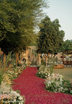 Outdoor Wedding Aisle with Red Rose Petals and Floral Decor
