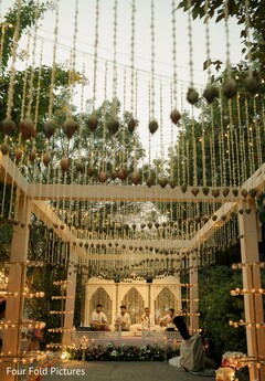 Outdoor Structure with Hanging Floral Decor and Musicians