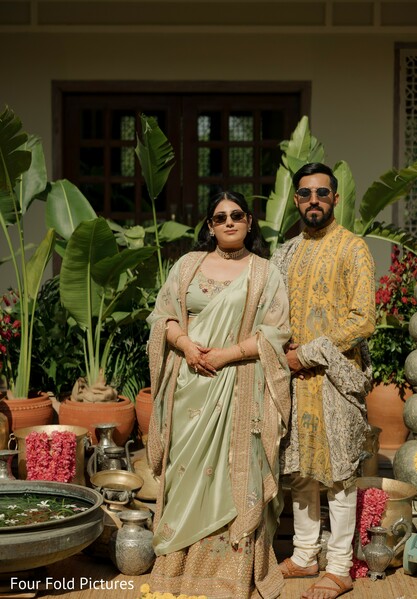 family portraits,haldi celebration,coordinated outfits,wedding guests,tropical decor,destination wedding,indian wedding,family style,pre wedding,group portrait