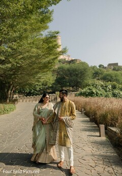 Couple in Traditional Attire on Stone Path