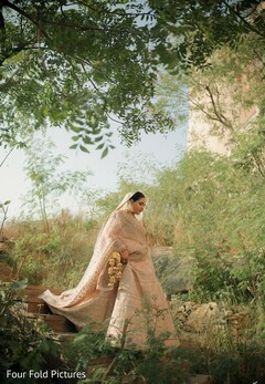 Bride in Light Gold Lehenga on Stone Steps
