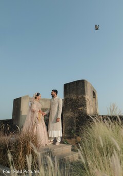 Couple in traditional wedding attire outdoors