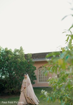 Bride in Embroidered Lehenga Posing Outdoors
