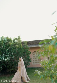Bride in Light Lehenga with Dupatta in Garden Setting