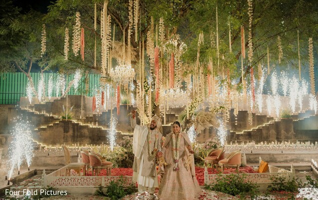 wedding celebration,indoor fireworks,newlyweds,floral decor,luxury wedding,reception,bride and groom,destination wedding,grand entrance,indian wedding