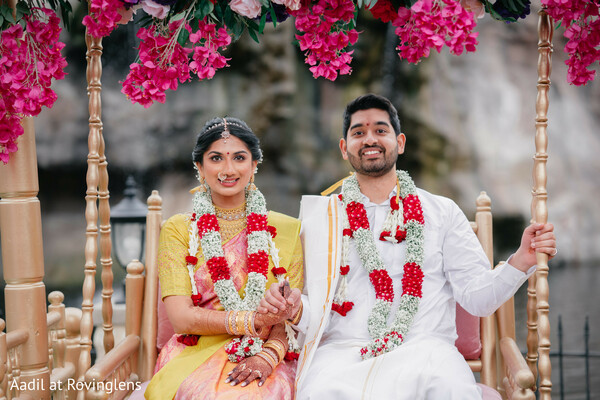 south indian wedding,hindu wedding,floral garlands,wedding ceremony,bride,groom,traditional attire,golden swing,couple portrait,wedding decor,yellow saree,white kurta