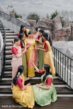South Indian Bride in Yellow Saree with Bridesmaids on Staircase