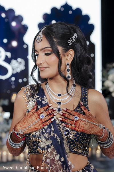 bridal portrait,navy blue lehenga,sapphire jewelry,diamond necklace,bridal earrings,maang tikka,mehndi,bridal fashion,embroidered lehenga,bridal jewelry,hair accessories