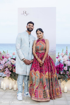 Couple Posing in Front of Decor and Water Backdrop