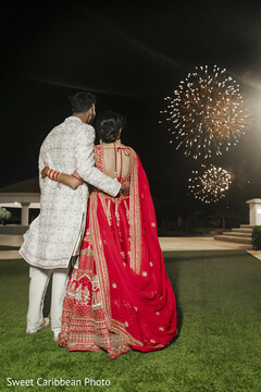 Couple in Traditional Attire Watching Fireworks at Night