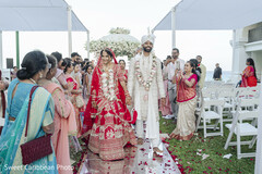 Couple's Grand Entrance on Red Carpet Aisle with Floral Decor