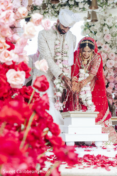 Couple in Red and White Outfits During Wedding Ceremony