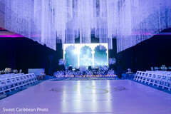 Elegant Ceremony Decor with Blue Lighting and Floral Accents