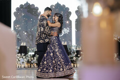 Couple's First Dance with Blue and Gold Outfits and Floral Decor