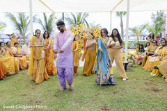 Outdoor pre-wedding celebration with guests dancing