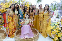 Bride in Pink Lehenga with Women in Yellow and Orange Attire