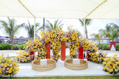Outdoor Ceremony Decor with Yellow and Pink Floral Arch