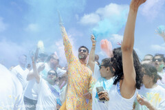 Vibrant Powder Celebration with Guests in White Attire