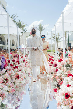 Groom in Sherwani Walks Down Aisle with Floral Decor