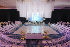 Elegant Wedding Ceremony Setup with White Chairs and Chandelier Decor