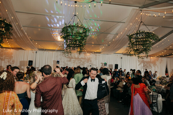 Lively Reception Dance Floor Under Greenery Chandeliers