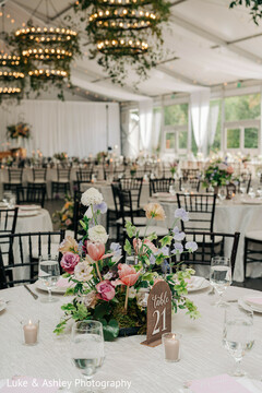 Pastel Floral Centerpieces and Chandeliers with Greenery Adorn Reception Tables