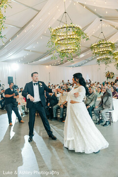 Couple's First Dance Under Draped Ceiling with Greenery Chandeliers