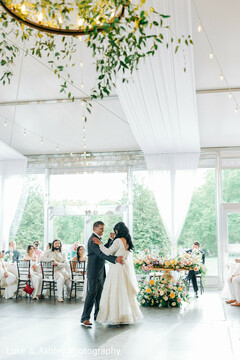 Elegant First Dance in a Bright, Floral-Adorned Reception Space