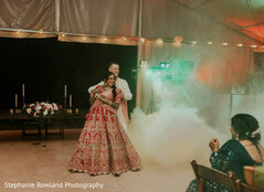 Couple dancing in tent with fog and candlelight