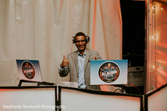 DJ with Headphones and Dual Laptops at Wedding Event
