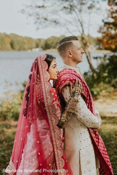 outdoor portraits,red lehenga,ivory kurta,mehndi,sheer dupatta,couple photo,wedding fashion,lake background,bridal fashion,groom fashion