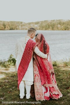 Couple in Traditional Attire by Lake for Wedding Photo Session